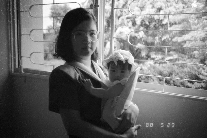 A partially restored digital image of my mum with my sister with Clementi Woods in the background